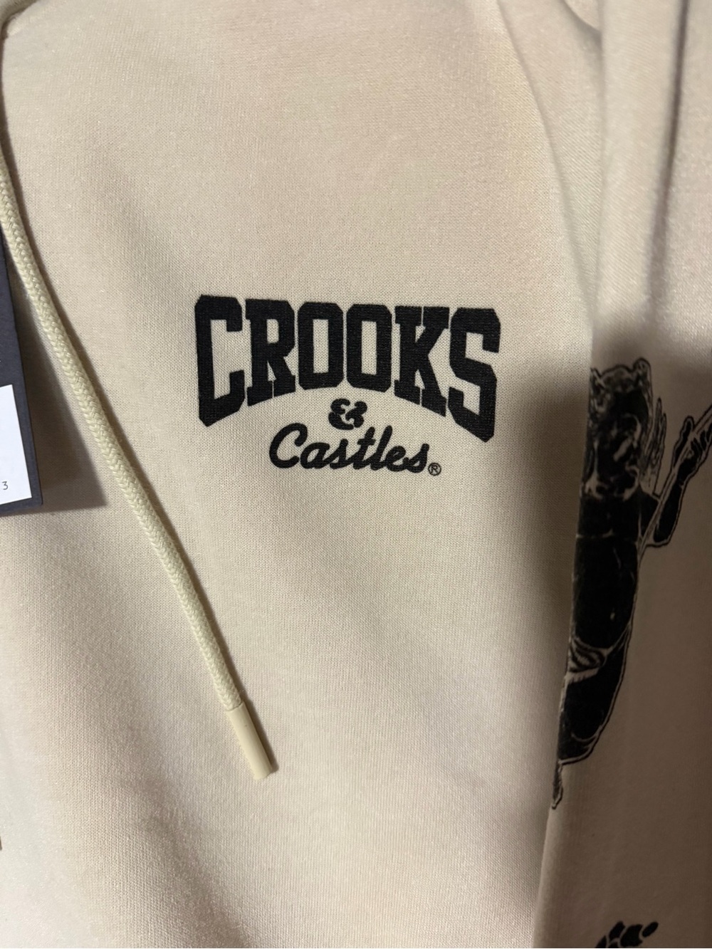 Crooks & Castles Cream Pullover Hoodie with Black Graphic Details - Picture 2 of 5